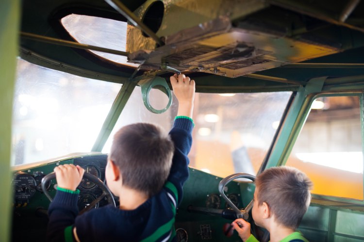 Kids in the cockpit of a Cessna Crane